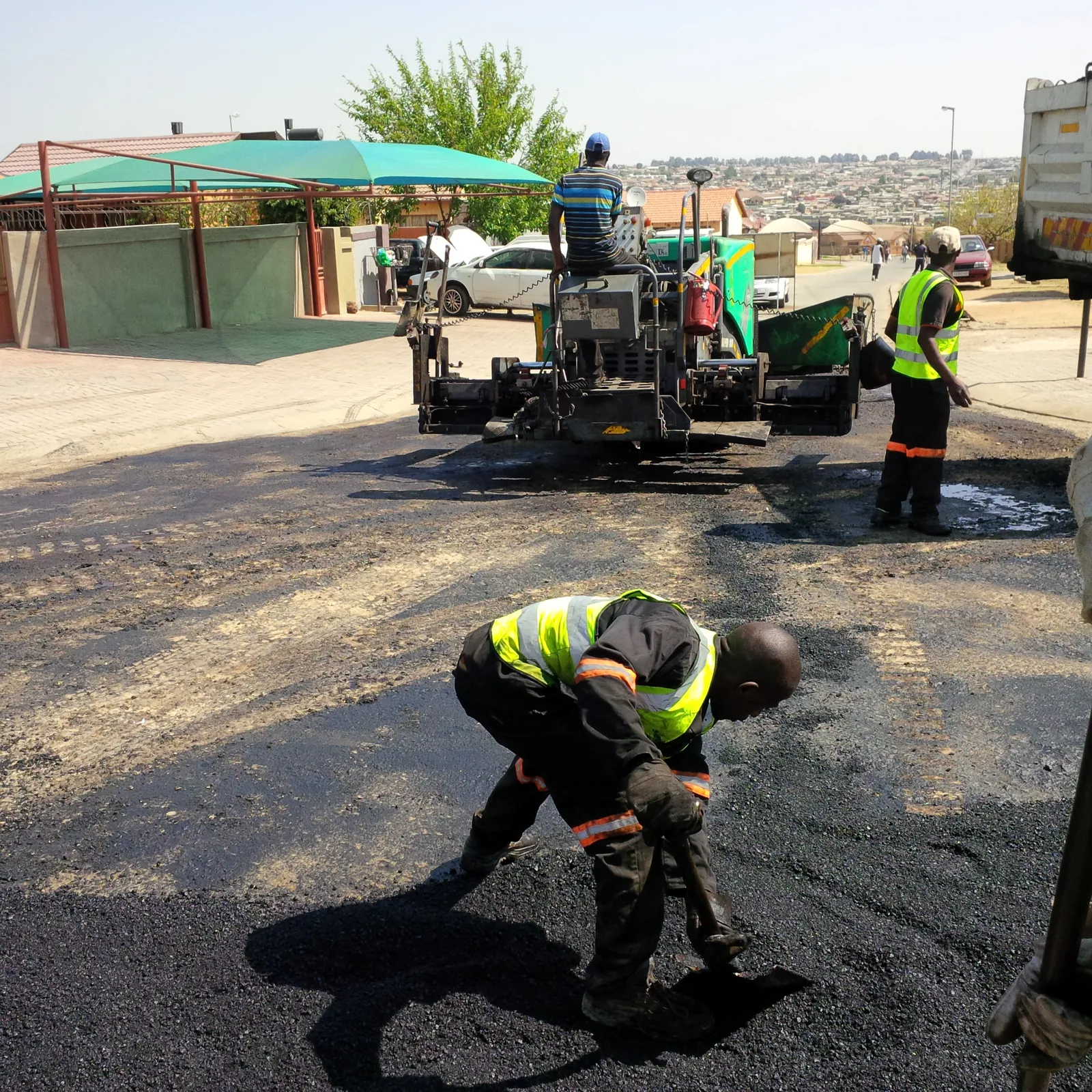 Asphalt placement and hand finishing
