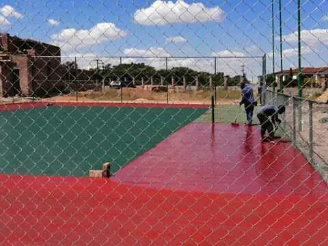Court surface and perimeter fencing